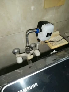 Automatic water booster pump installation connected with washing machine supply.